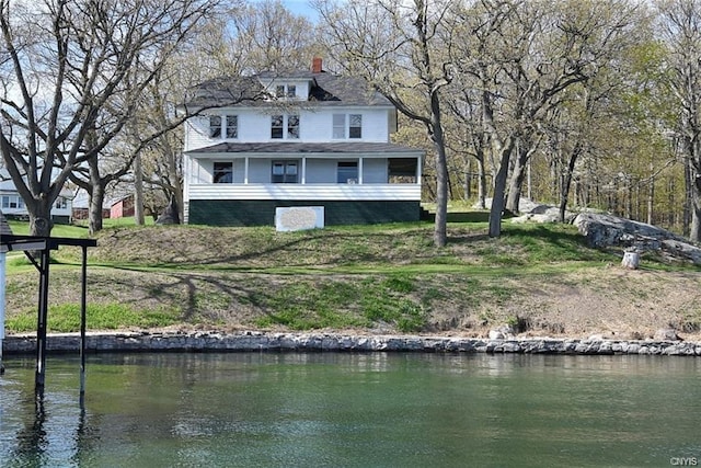 back of property with a water view