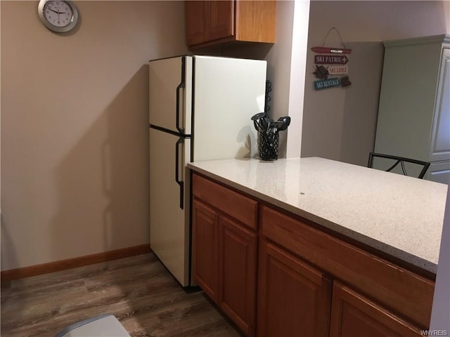 kitchen featuring white refrigerator and dark hardwood / wood-style floors