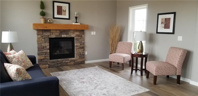 interior space with dark hardwood / wood-style flooring and a stone fireplace