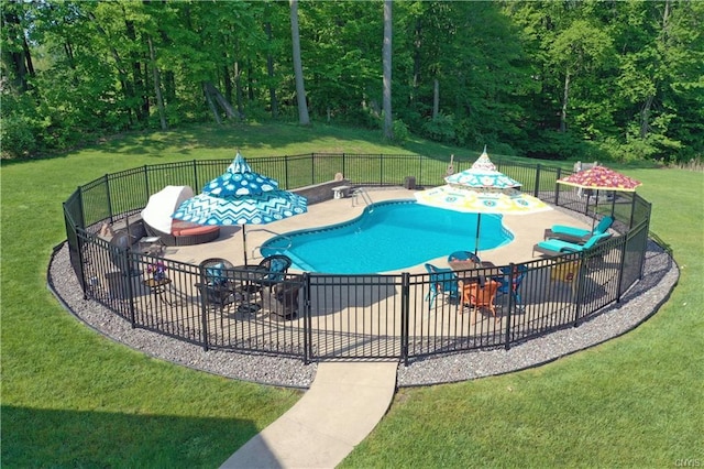 view of swimming pool featuring a yard and a patio area