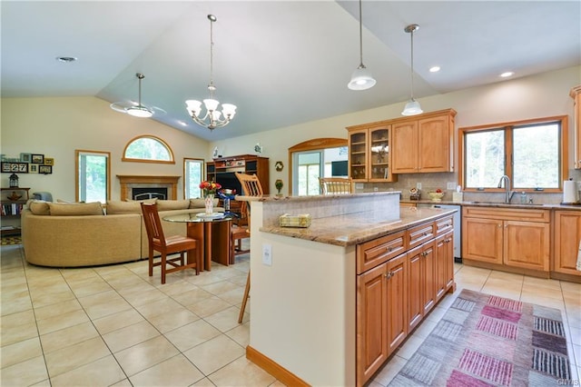 kitchen with pendant lighting, a center island, backsplash, sink, and a chandelier