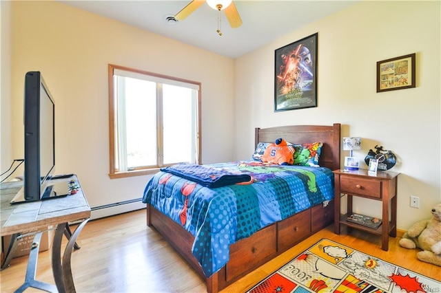 bedroom featuring ceiling fan, a baseboard radiator, and light hardwood / wood-style flooring