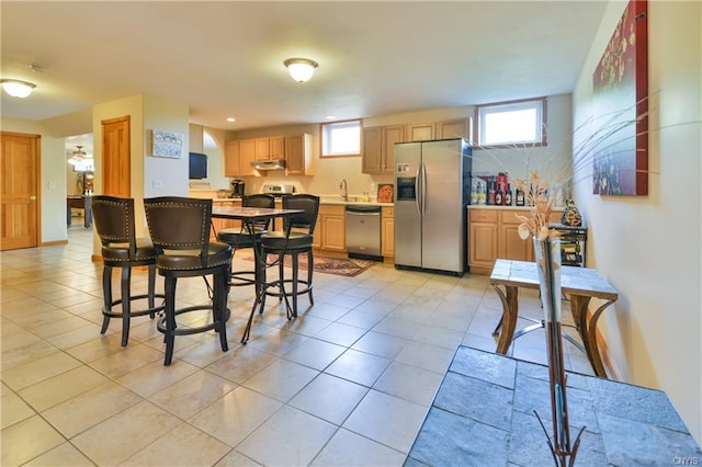 dining room with sink and light tile floors