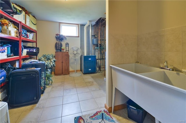 laundry area featuring tile walls and light tile floors