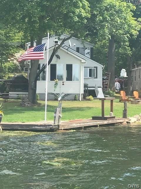 surrounding community featuring a water view and a yard