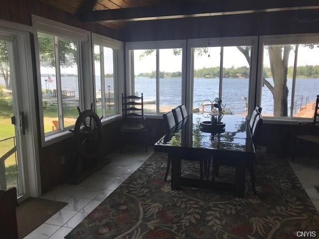 sunroom / solarium with a wealth of natural light and a water view