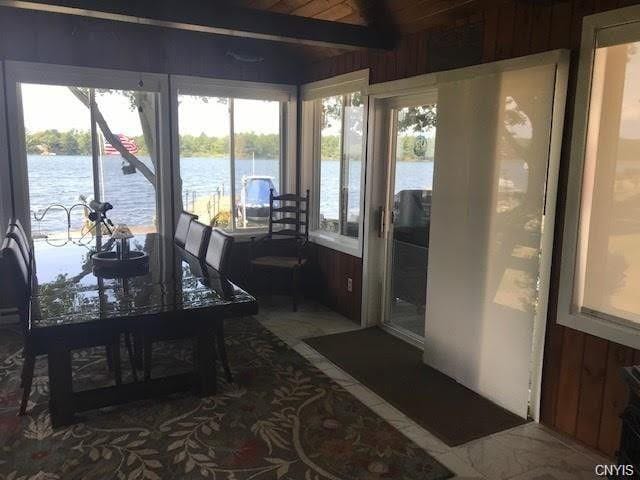 sunroom / solarium featuring a water view