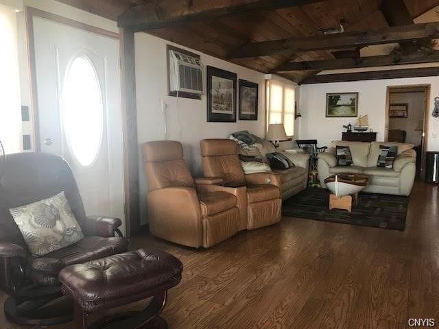 living room with wood ceiling, beam ceiling, a wall mounted air conditioner, and dark hardwood / wood-style flooring