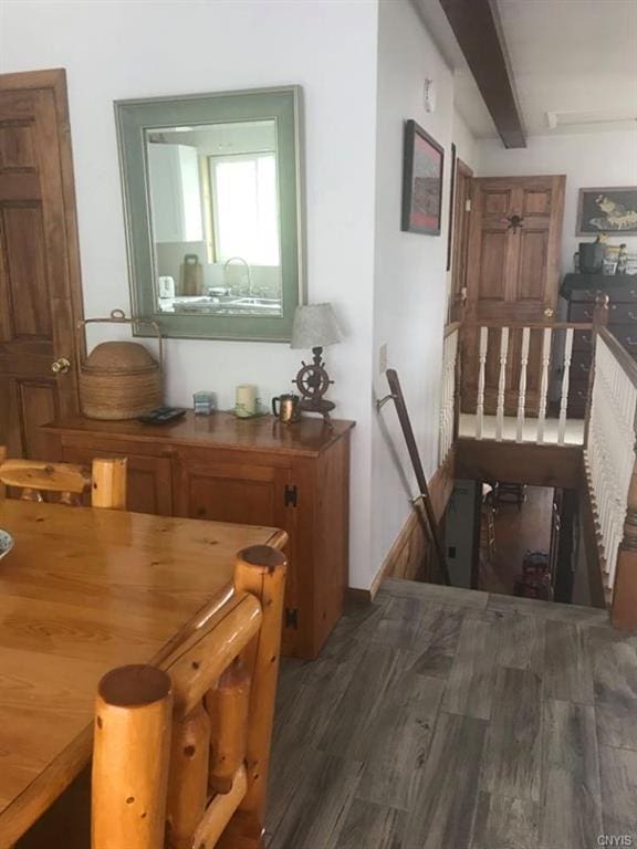 hall with dark wood-type flooring and beam ceiling