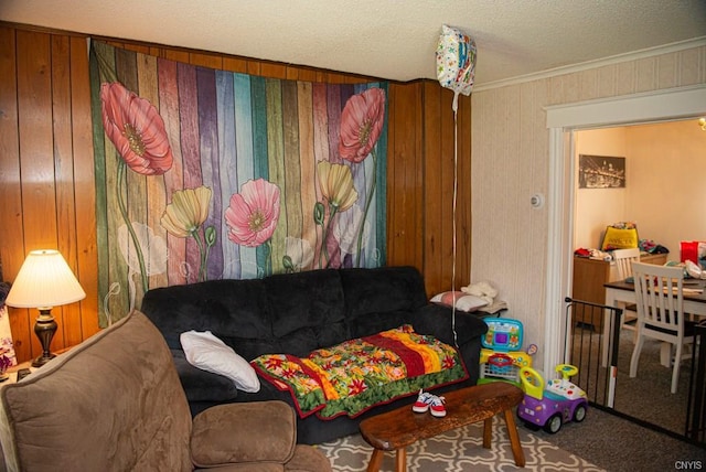 carpeted living room featuring wooden walls, ornamental molding, and a textured ceiling