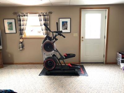 workout room with carpet floors and a drop ceiling