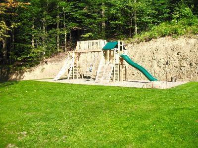 view of playground with a lawn