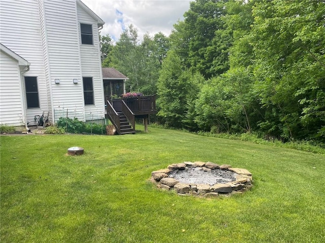 view of yard featuring a fire pit and a wooden deck