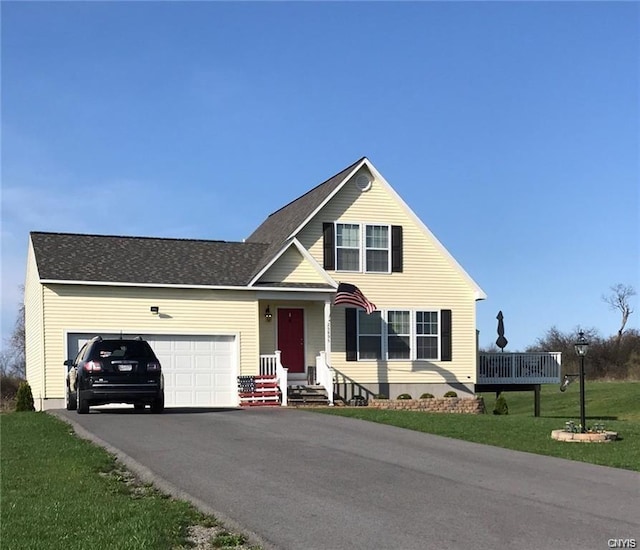 view of front of property with a front yard and a garage