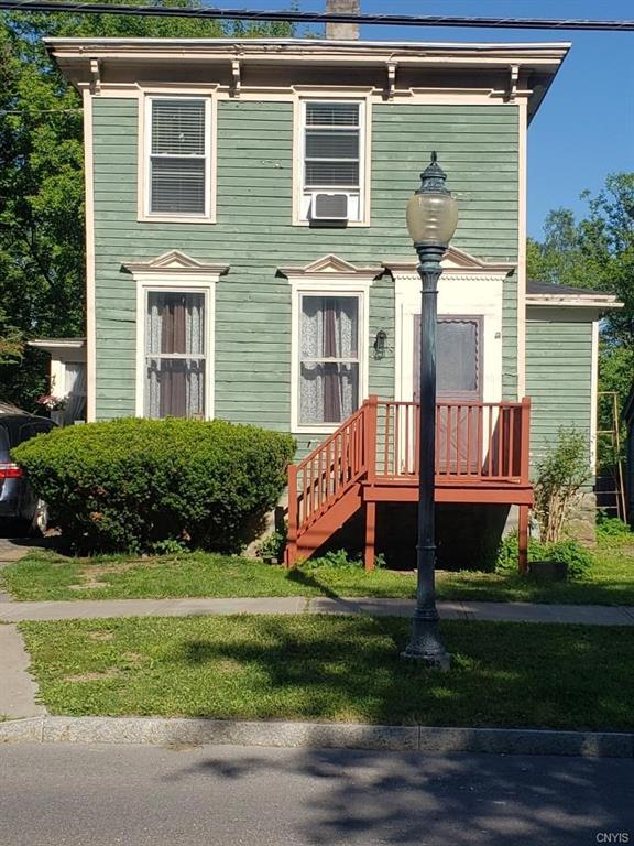 italianate home featuring a front yard