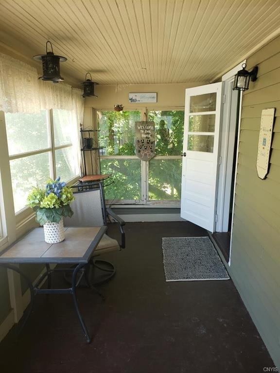 unfurnished sunroom featuring wood ceiling