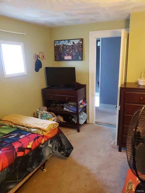 bedroom featuring light colored carpet