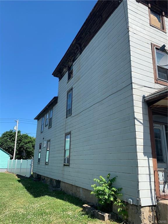 view of side of property with a yard