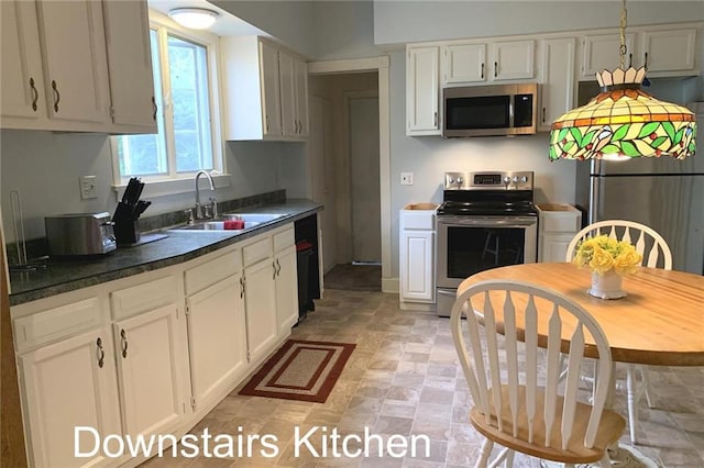 kitchen with white cabinets, sink, light tile floors, and stainless steel appliances