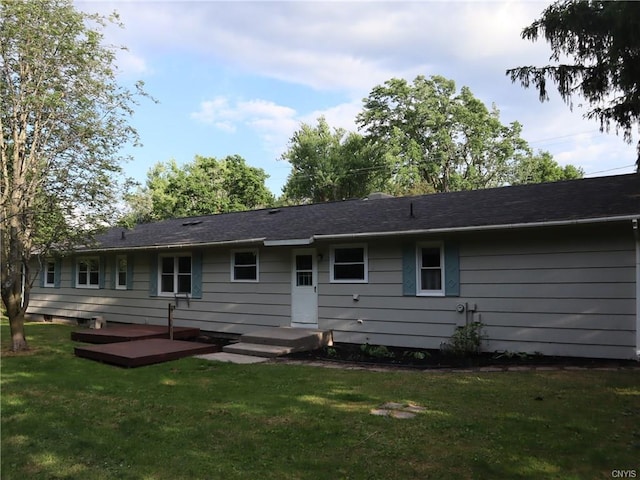 rear view of house featuring a yard