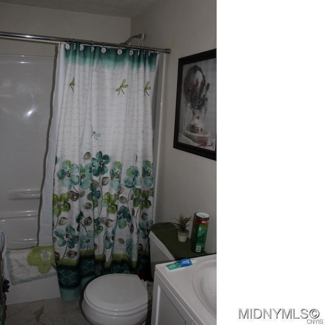 full bathroom featuring tile floors, toilet, shower / bath combo with shower curtain, and vanity