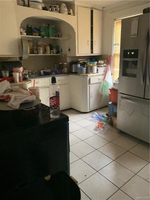 kitchen with light tile floors, white cabinetry, tasteful backsplash, and stainless steel refrigerator with ice dispenser