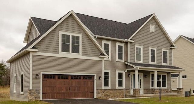 craftsman house featuring a porch, central AC, and a garage