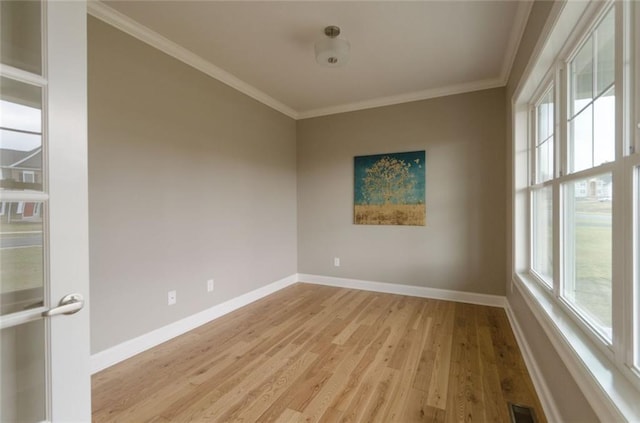 spare room with light hardwood / wood-style floors and ornamental molding