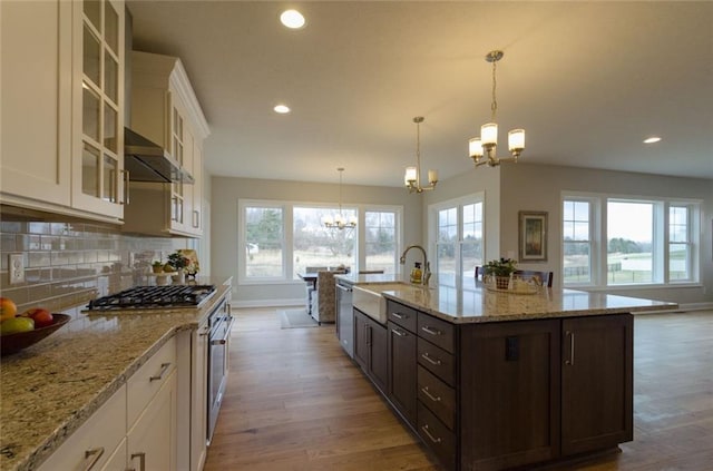 kitchen with white cabinetry, an inviting chandelier, tasteful backsplash, and dark brown cabinets