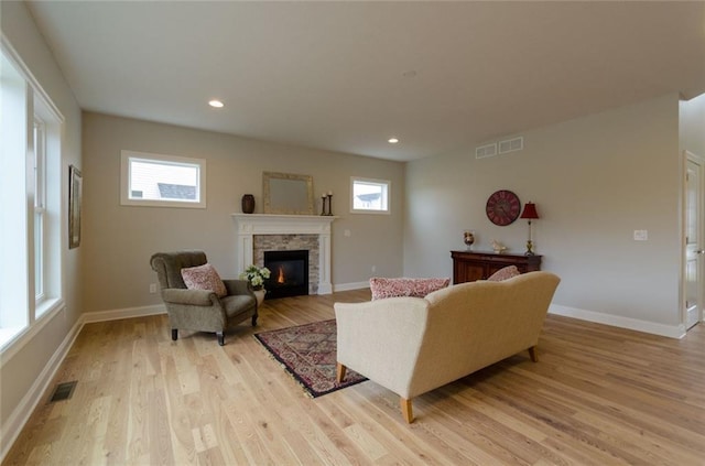 living room featuring light hardwood / wood-style floors and a fireplace