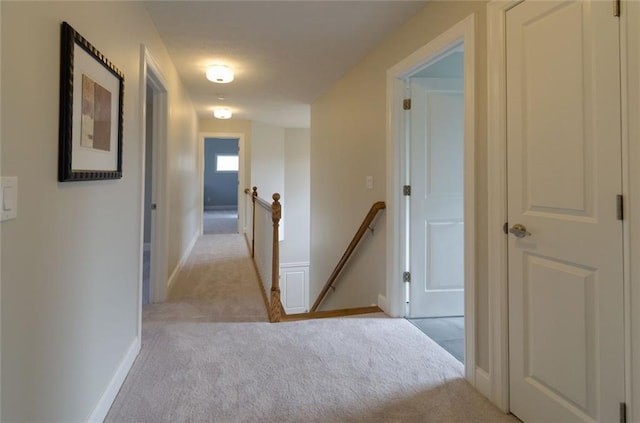 hallway featuring light carpet