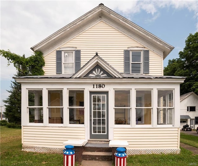 rear view of house featuring a yard