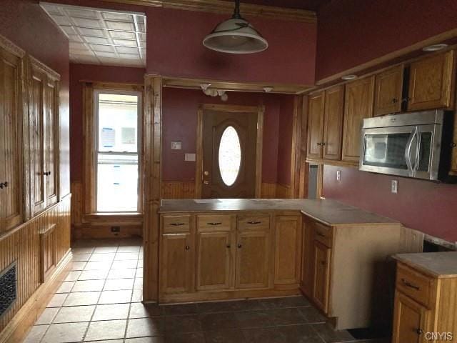 kitchen featuring light tile flooring and hanging light fixtures