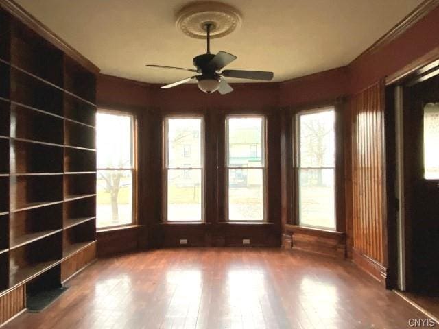 spare room with ceiling fan, dark hardwood / wood-style floors, and plenty of natural light