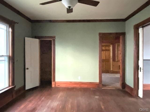 empty room with ceiling fan and dark wood-type flooring