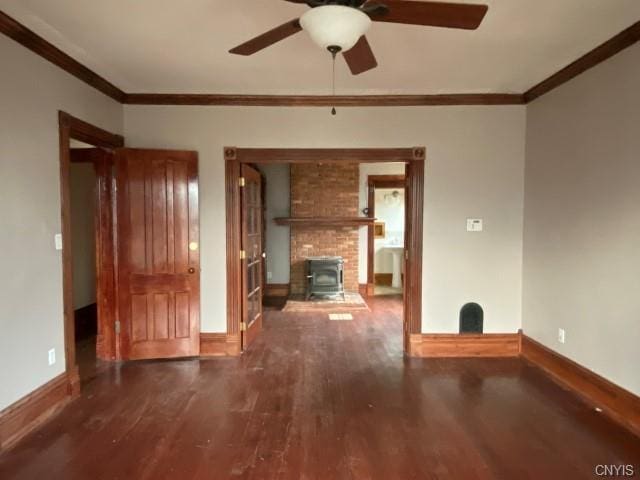 interior space with crown molding, brick wall, a fireplace, and dark hardwood / wood-style floors