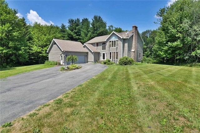 view of front of house with a front yard and a garage