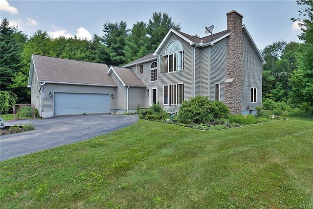 colonial home with a front yard and a garage