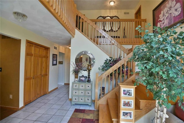 staircase featuring light tile floors