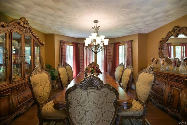 dining area featuring plenty of natural light, dark hardwood / wood-style floors, and a notable chandelier