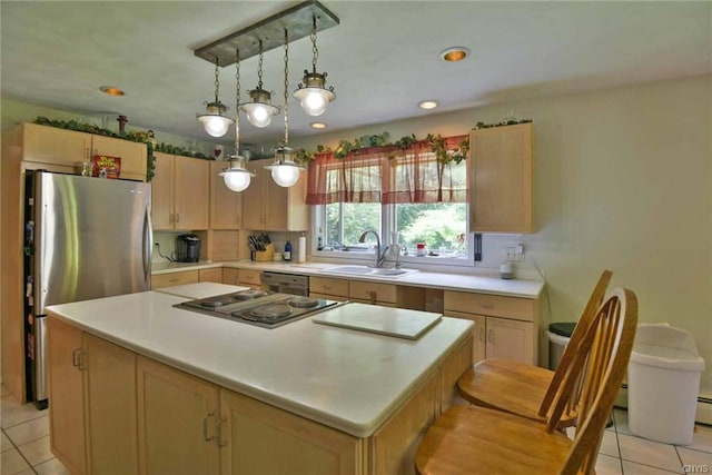 kitchen featuring light tile floors, a kitchen island, appliances with stainless steel finishes, hanging light fixtures, and sink