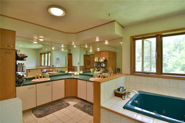 bathroom with a relaxing tiled bath, vanity, and tile flooring