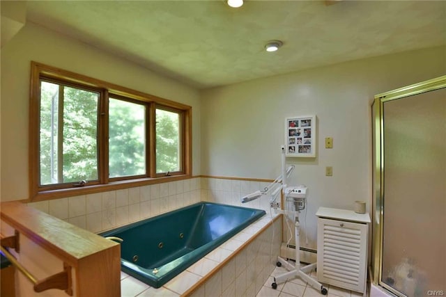 bathroom with independent shower and bath, tile floors, a baseboard heating unit, and a wealth of natural light