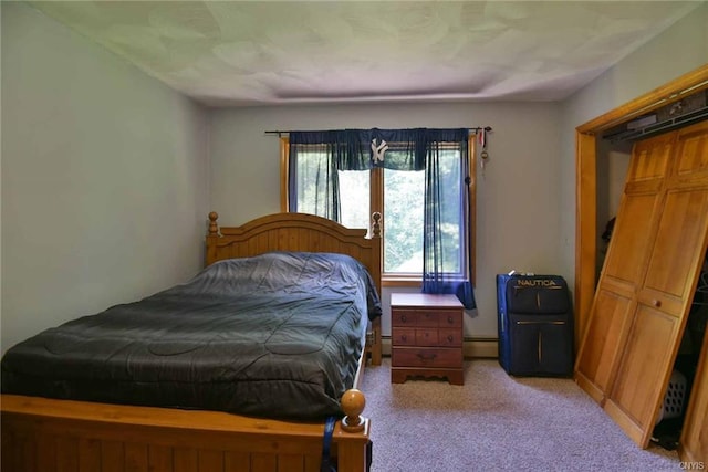 carpeted bedroom with a baseboard heating unit