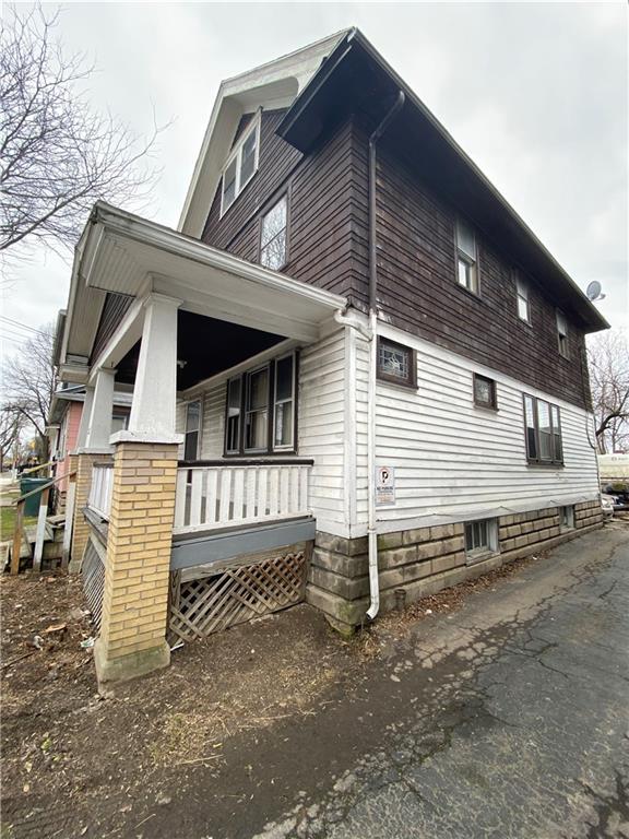 view of side of home with covered porch