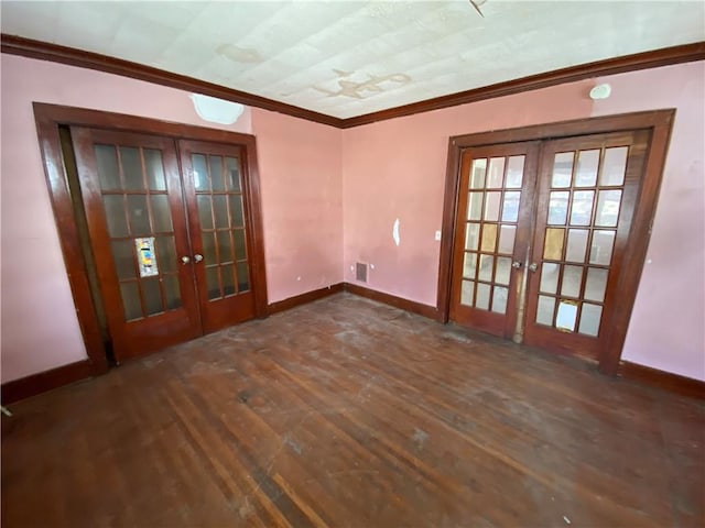 empty room featuring crown molding, dark hardwood / wood-style floors, and french doors