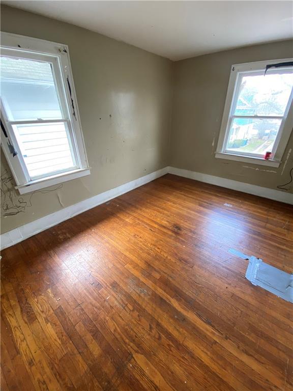 unfurnished room featuring dark hardwood / wood-style floors