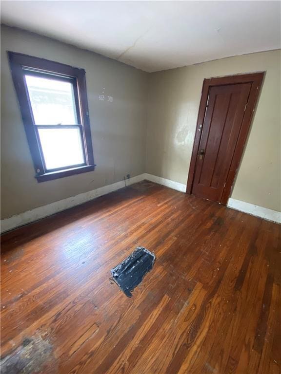 spare room featuring dark wood-type flooring