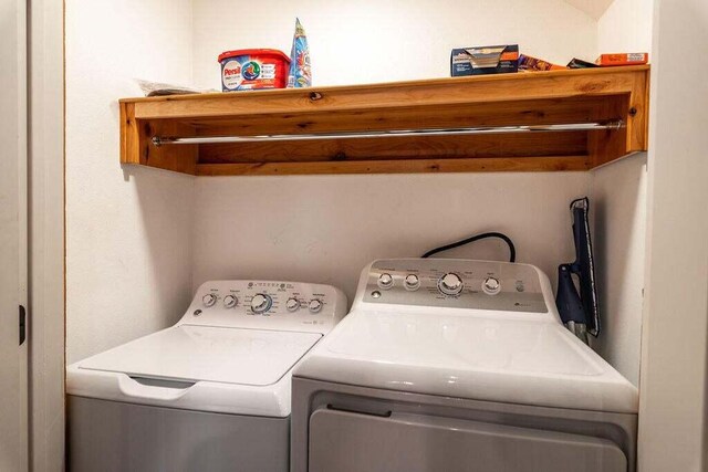 laundry room featuring washing machine and clothes dryer