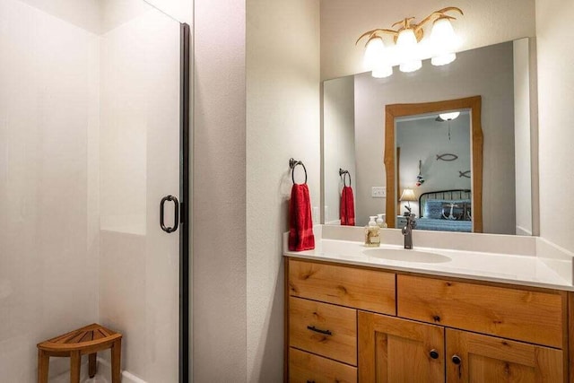 bathroom with vanity and a shower with door